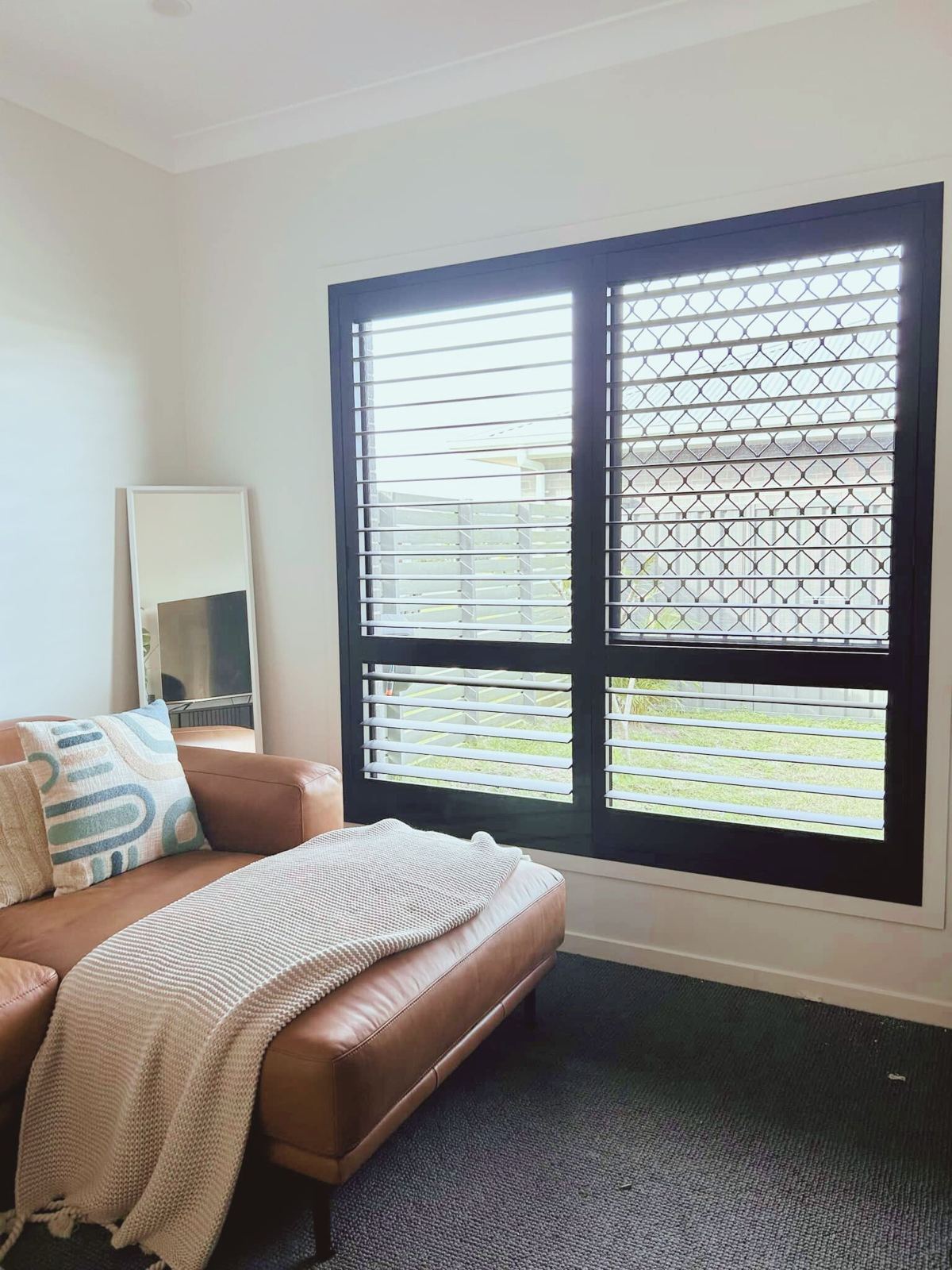 Aluminium shutters on a window in Fullerton Cove