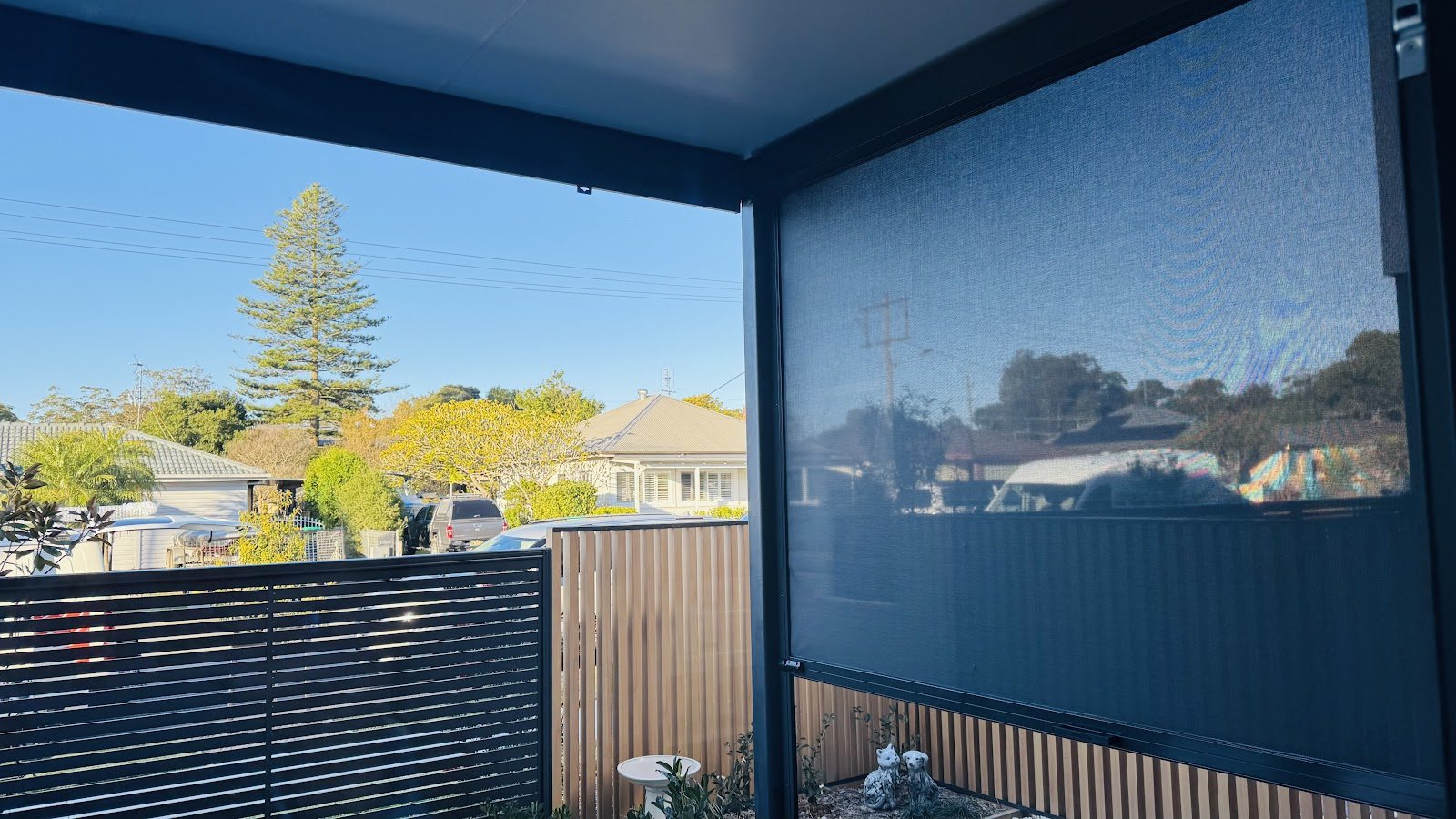 Outdoor blinds lowered across a courtyard patio