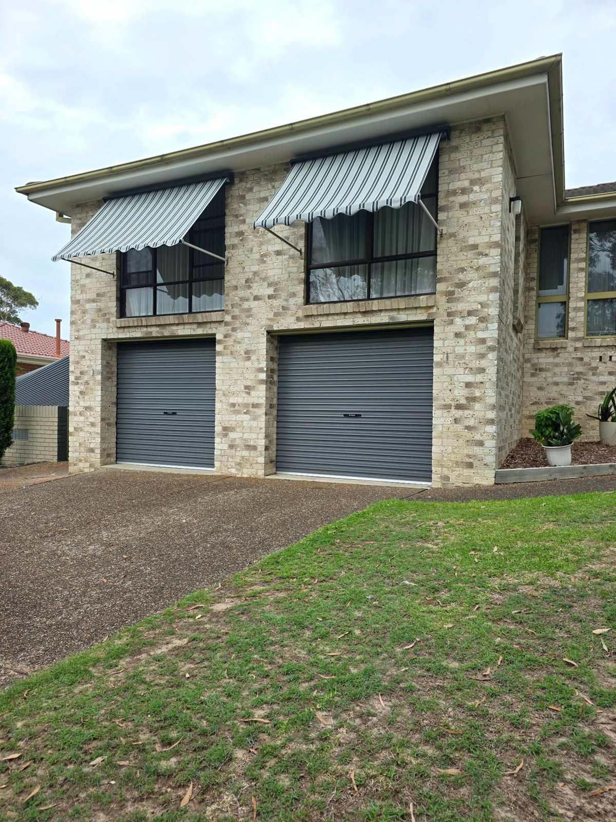 Pivot arm awnings on a two storey home in Jewells