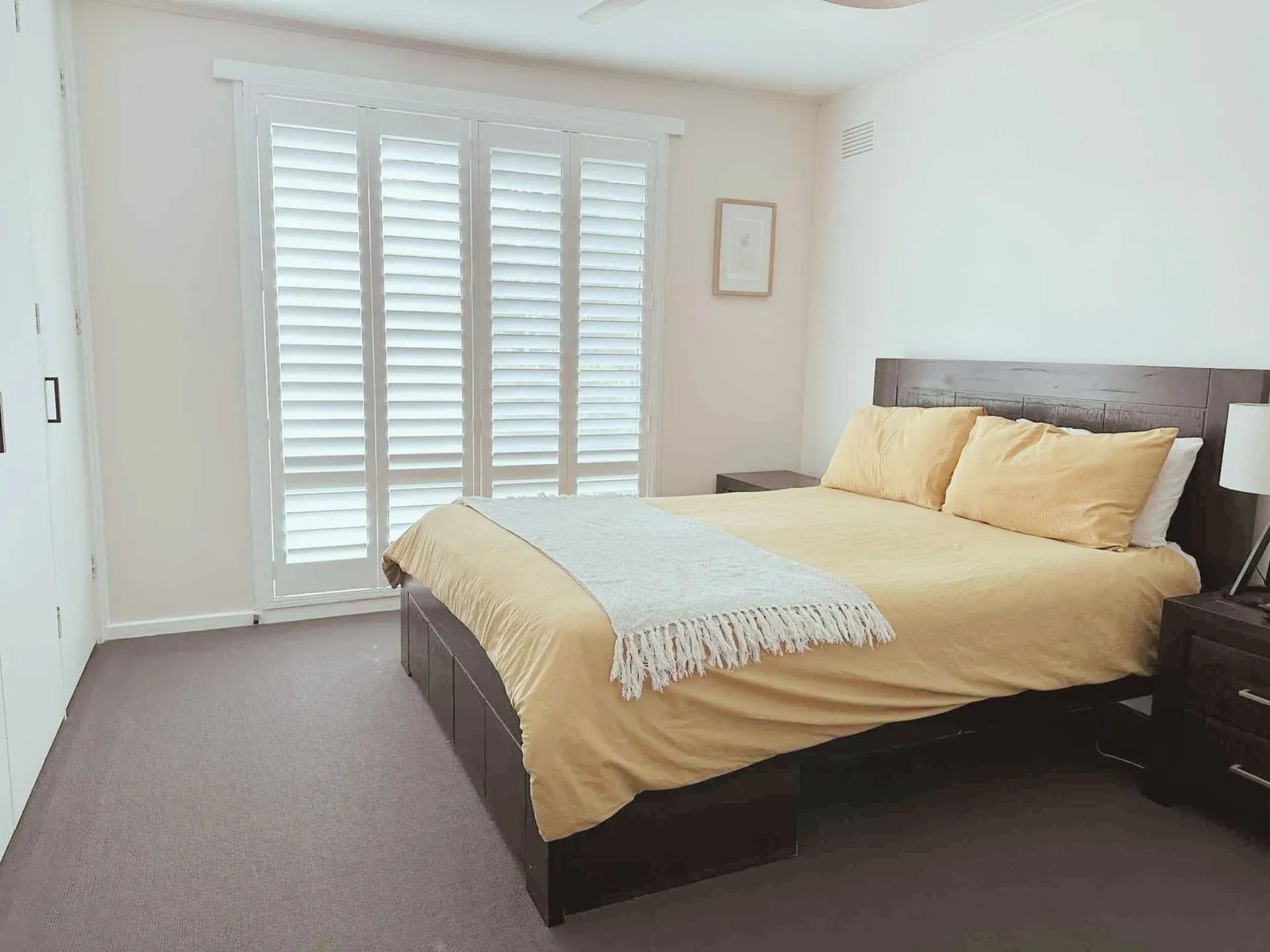 White plantation shutters in a bedroom in Raymond Terrace