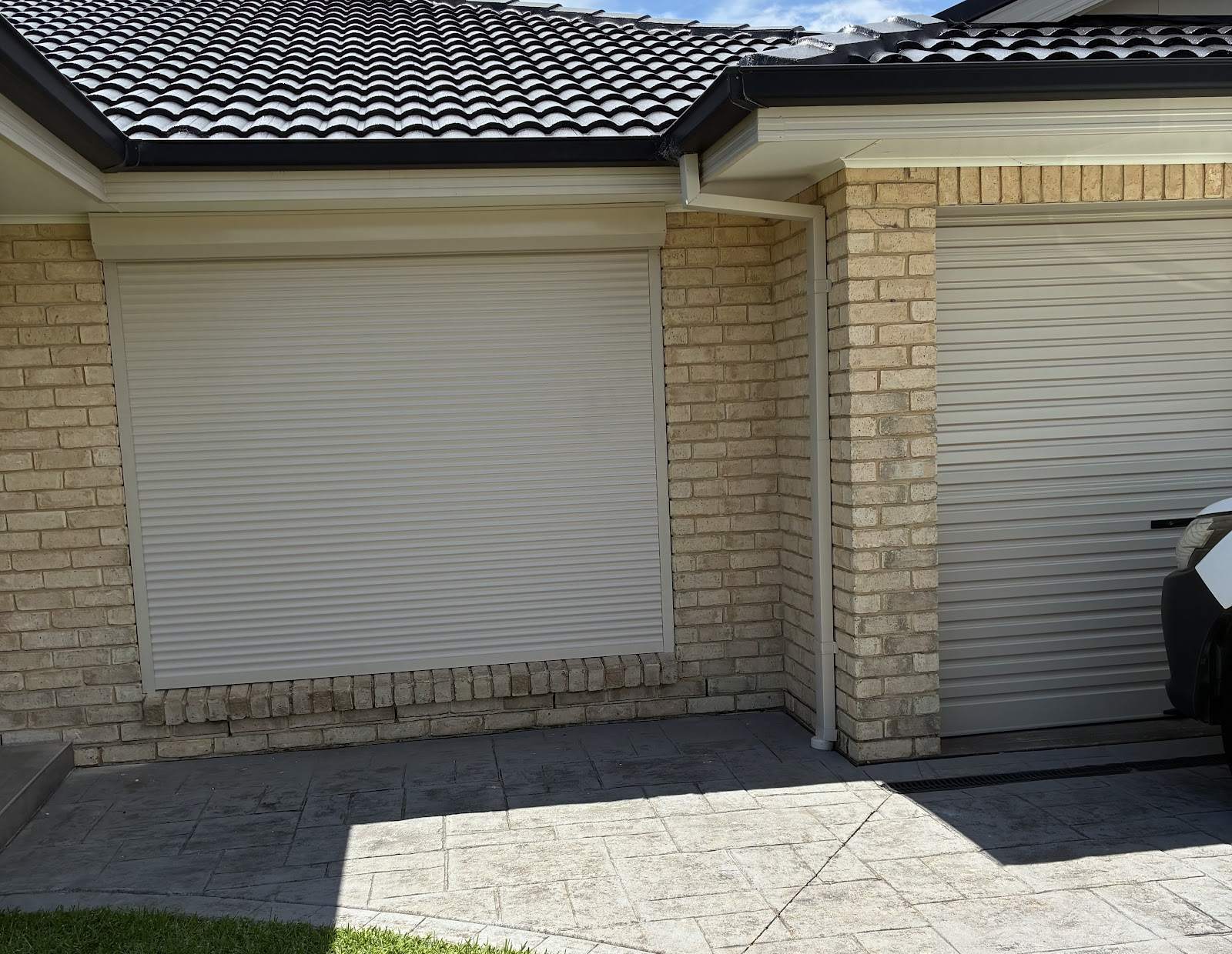 Roller shutters on the front of a brick home