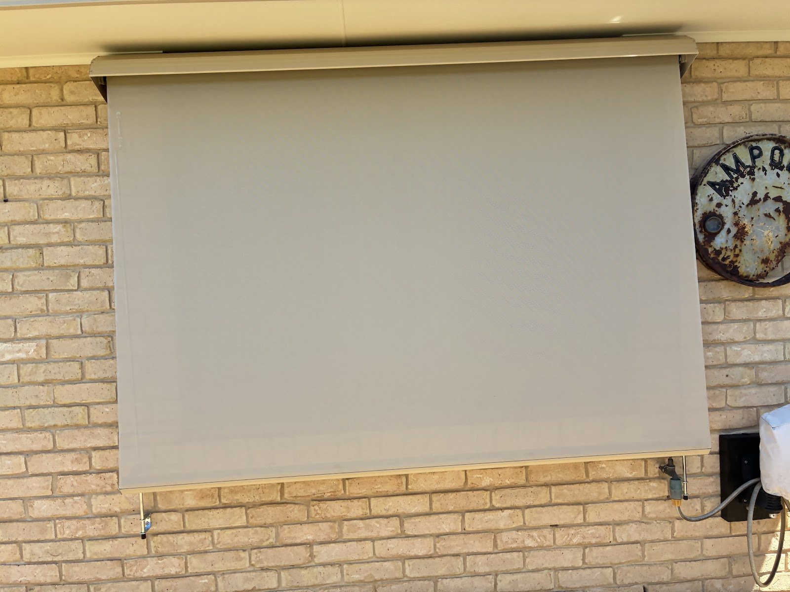 Straight drop awning on a brick home window