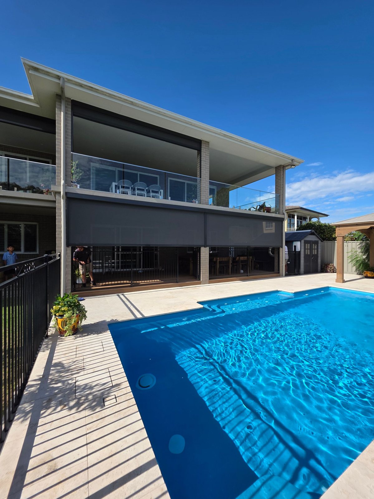 Zip screens on a two storey home with a pool in Valentine